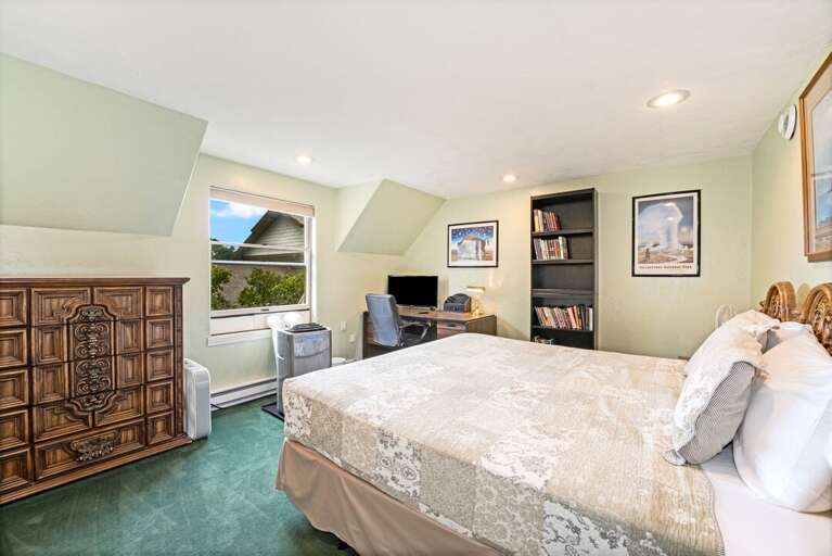 King bed with TV and desk. | Second Level