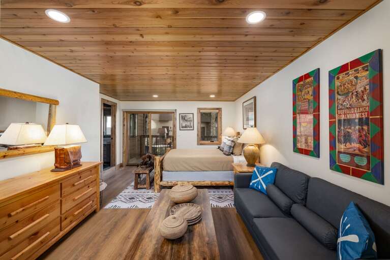 A sofa, dresser and coffee table make the primary bedroom feel like its own little lounge.
