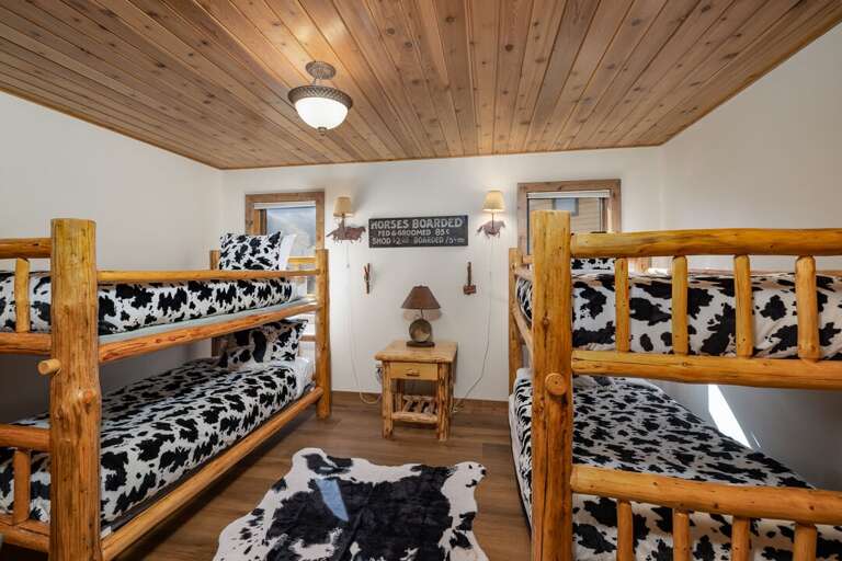 Two sets of twin over twin log bunks make this the favorite room for kids and friends alike.