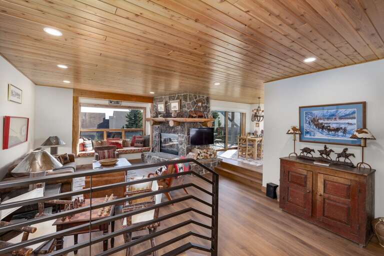 Wood ceilings, Western art and a stone fireplace give the main living space real Montana character.