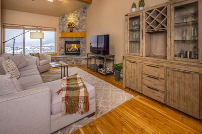 Light the wood-burning stone fireplace, sink into the sectional and watch the snow settle over the meadow.