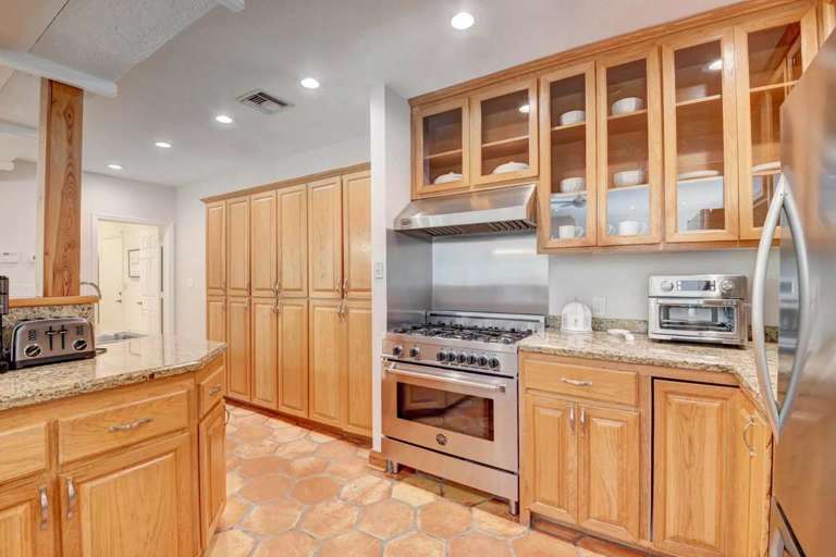 Residential Kitchen Interior With Wooden Cabinets And Terracotta Floor Tiles Residential Kitchen Interior With Wooden Cabinets And Terracotta Floor Tiles