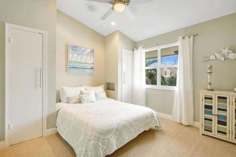 Bright Bedroom With Bed, Window, And Ceiling Fan Bright Bedroom With Bed, Window, And Ceiling Fan