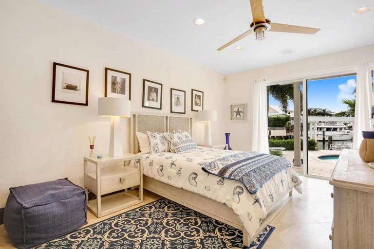 Bedroom With Bed, Ceiling Fan, And Sliding Door Access To Outside Bedroom With Bed, Ceiling Fan, And Sliding Door Access To Outside