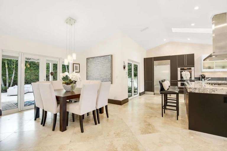 Interior Showing Dining Area With Table And Chairs And Adjacent Kitchen With Countertop Interior Showing Dining Area With Table And Chairs And Adjacent Kitchen With Countertop