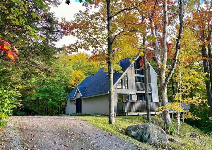 A-frame House Surrounded By Autumn Foliage A-frame House Surrounded By Autumn Foliage