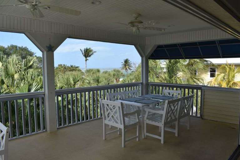 Lanai with ocean views and plenty of seating