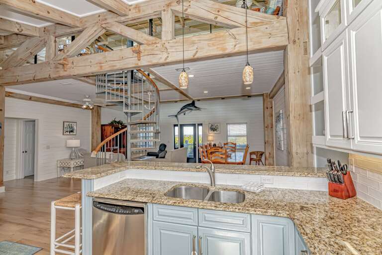 Kitchen Counter With Spiral Staircase And Wooden Beams