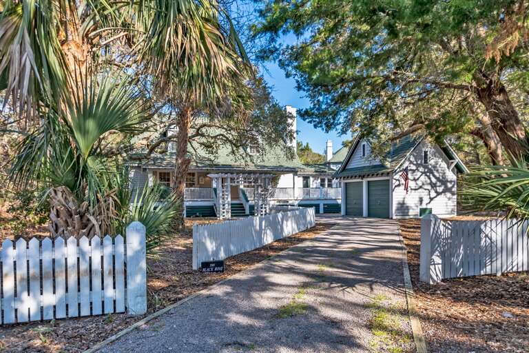 Vacation Rental Veiled By Vibrant Vegetation, Viewed Via Vehicle-ready Avenue