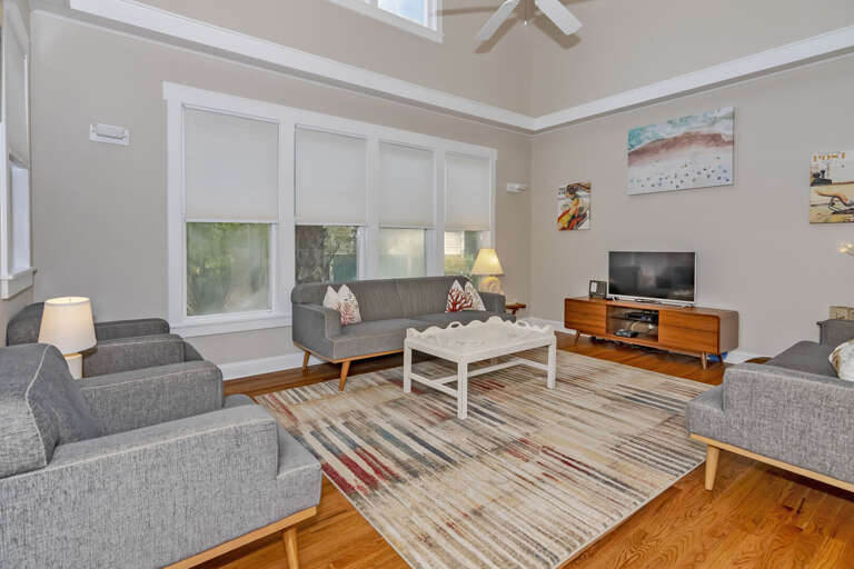 Light-filled Living Space Sporting Sleek Sofas And A Subtle Striped Rug