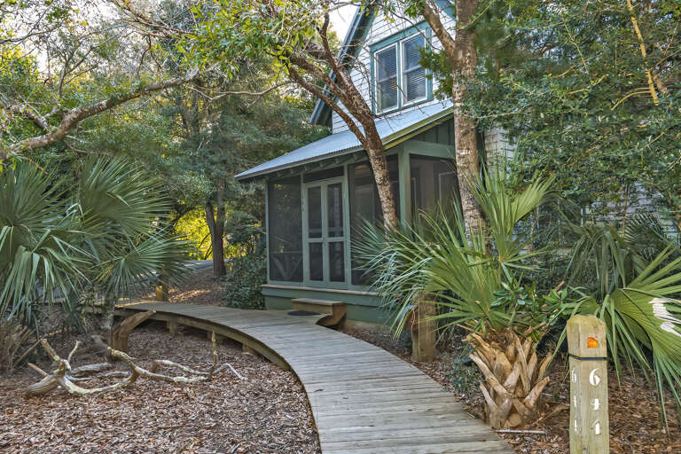Pathway Leading To Secluded House Surrounded By Greenery