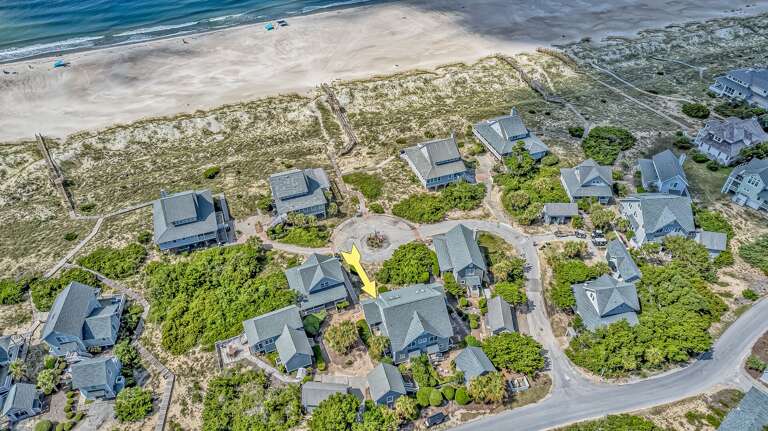 Aerial View Of Seashore Structures By Sandy Shore