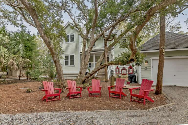 Tree-shaded Residence With Red Chairs Arrayed