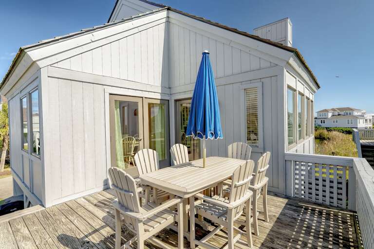 White Wooden Structure With Blue Umbrella On Sunny Deck