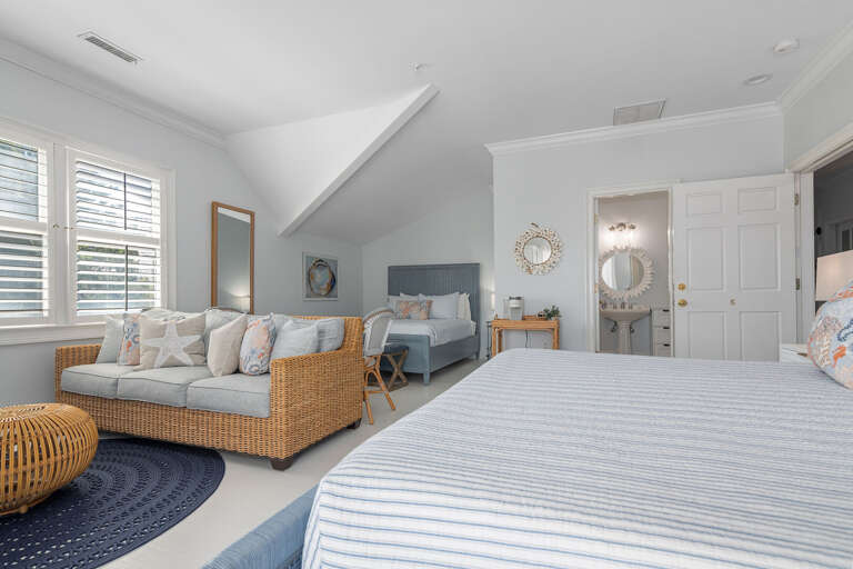 Spacious Vacation Rental Room, Blue Bed With Wicker Seating