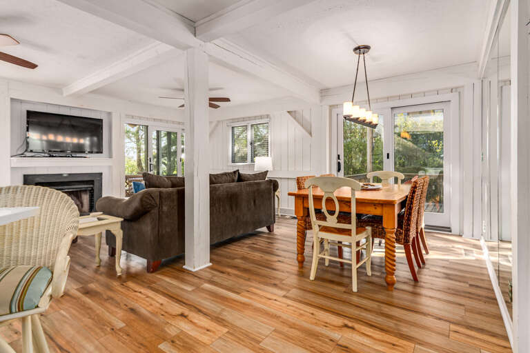 Bright, Breezy Living Space With Wooden Floors, White Walls, And Ample Windows