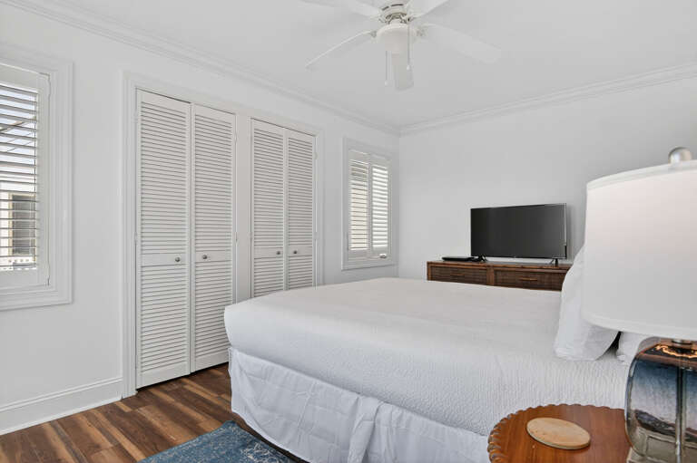 Bed, Blinds, And Bureau In A Bright Bedroom