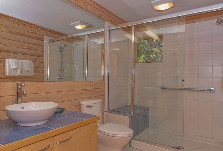 Bathroom With Shower Cabin, Toilet, And Sink
