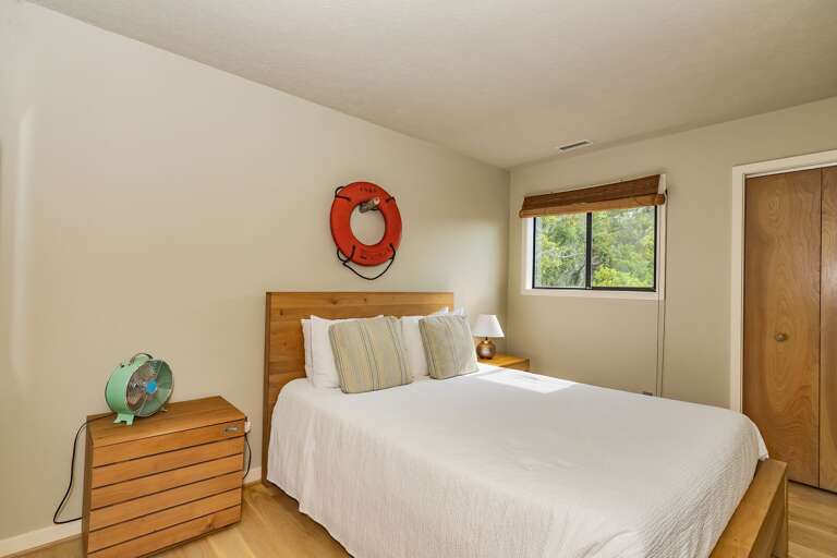 Bedroom Boasting Basic Bedding, Blonde Bureau, Buoy On Beige Backdrop