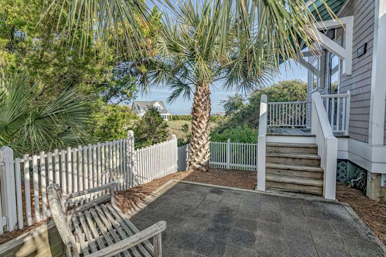 Patio With Palms, Fence, And Stairs