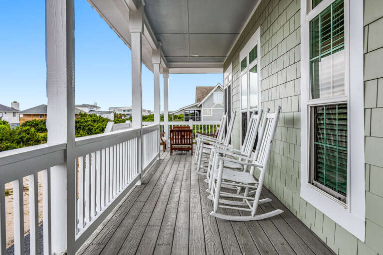 Seaside Porch With White Rocking Chairs, Bright Light, And Breezy Vibes