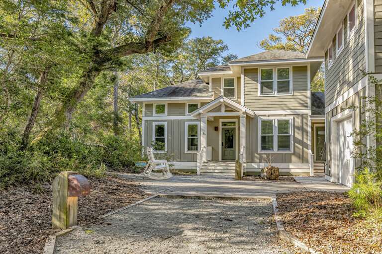 Beige Building Bordered By Trees, Tranquil Terrace With Swing