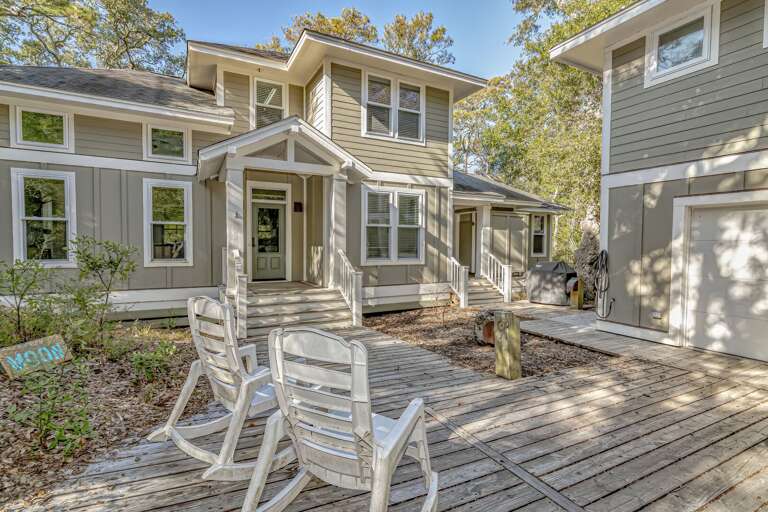 Wooden Chairs On Deck, Double Storey Building, Dense Trees