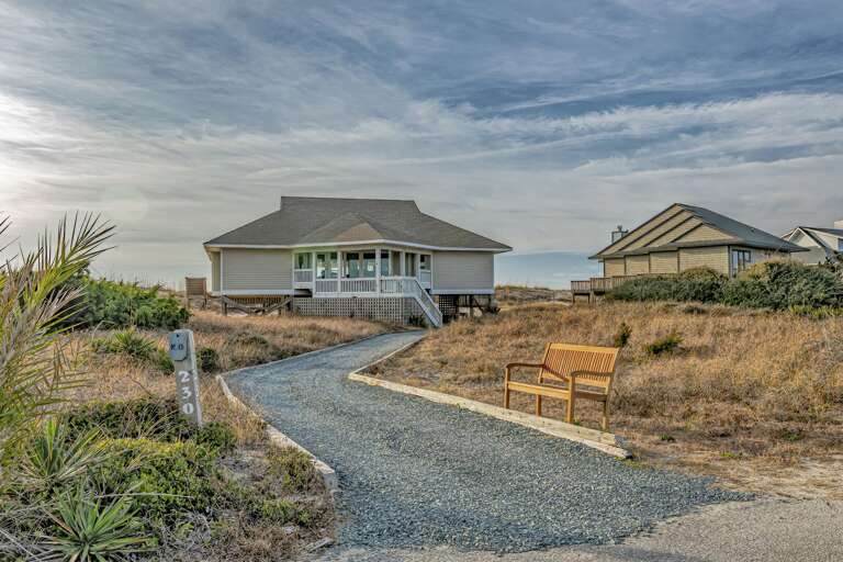 Seaside Structure Surrounded By Sandy Scrub And Skyline