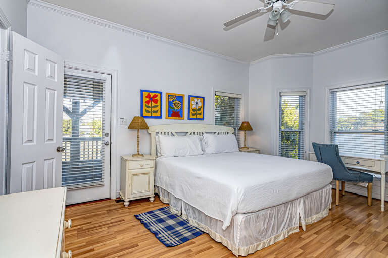 Bright Bedroom With Blue Accents And Multiple Windows