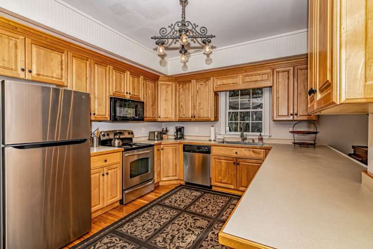 Spacious Kitchen With Wooden Cabinets And Stainless Steel Appliances
