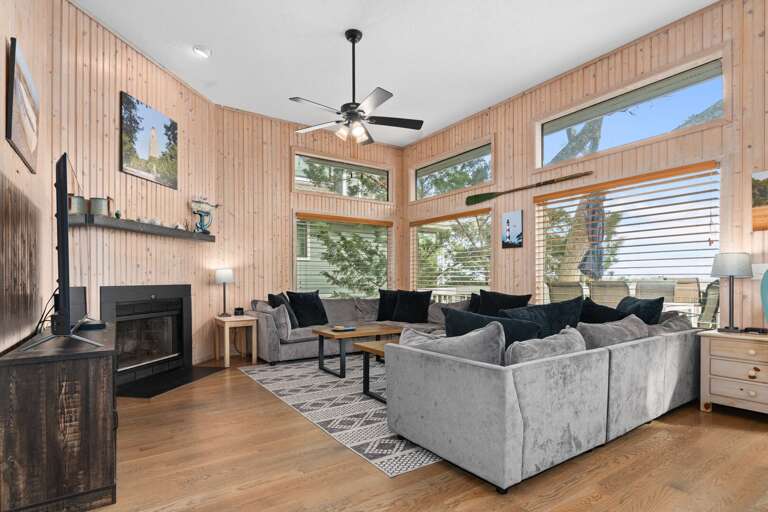 Sunlit Sitting Space, Sofas Surrounding A Central Fireplace, Scenic Views Through Large Windows