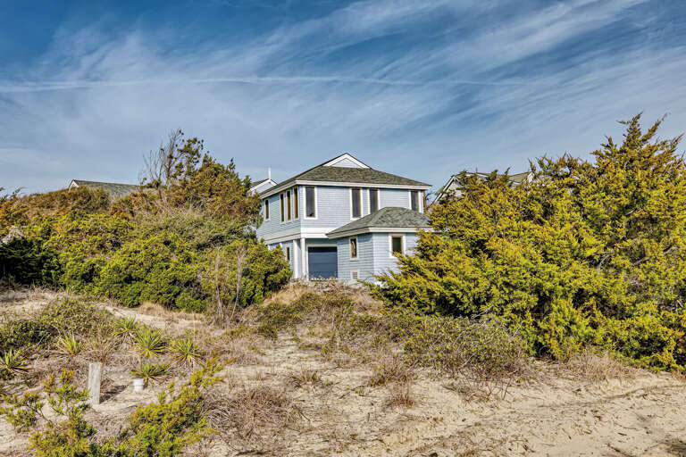 Beach House Surrounded By Sand And Shrubs Beach House Surrounded By Sand And Shrubs