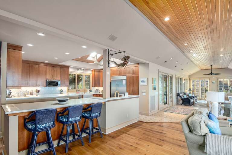 Spacious Kitchen With Bar Stools, Flowing Floorplan Leading To Living Area Spacious Kitchen With Bar Stools, Flowing Floorplan Leading To Living Area