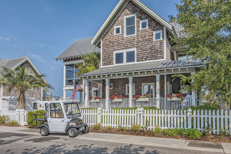 Wooden Structure With White Picket Fence And Parked Golf Cart