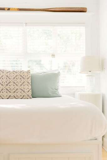 Bright Bedroom With White Bedding And Decorative Pillows
