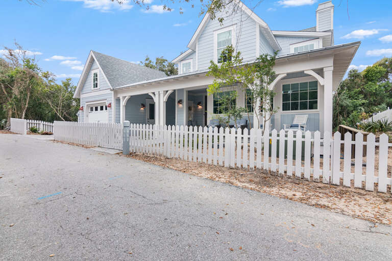 White Wooden Vacation Rental With Picket Fence