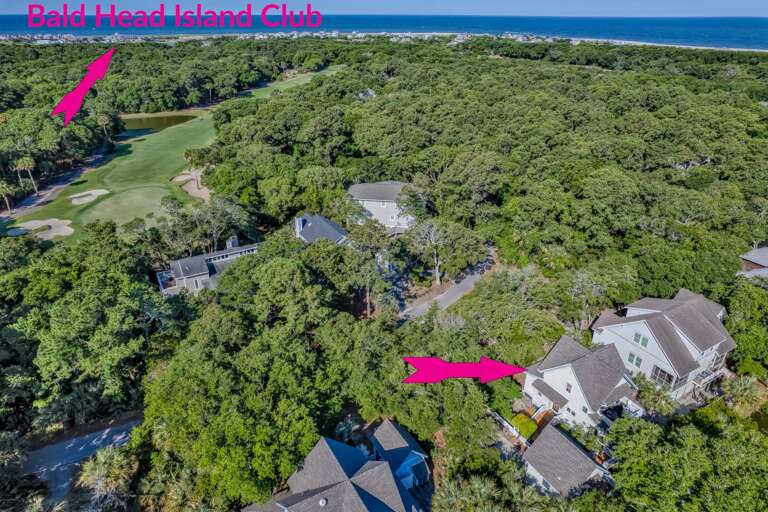 Aerial View Of Lush Green Landscape Dotted With Residential Structures Near A Golf Course
