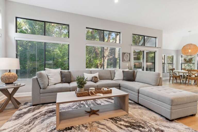 Spacious Living Room Interior With Sectional Sofa And Large Windows