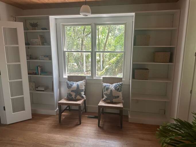 Interior Room With Chairs, Bookshelf, And Window View