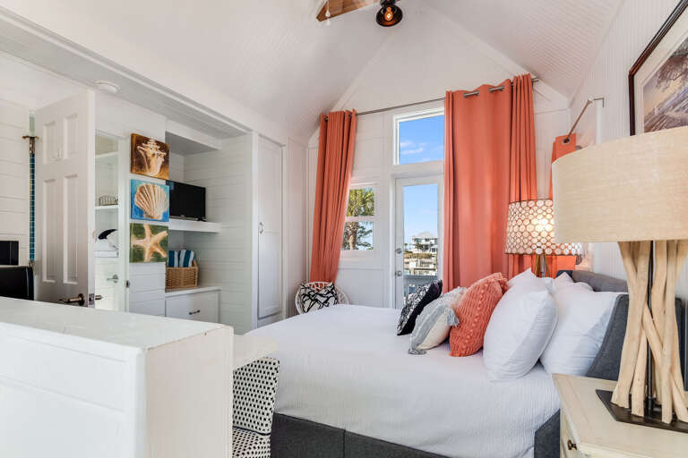 Bright, Breezy Room With White Walls, Coral Curtains, And Sea Views