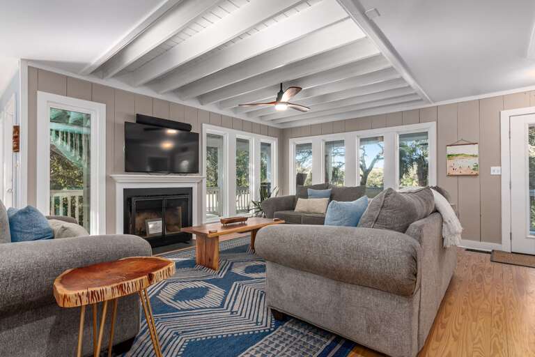 Spacious Living Room With Sofa Set, Fireplace, And Multiple Windows