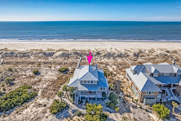 Aerial View Of Beachfront Building Beside Sea And Sand
