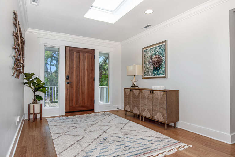 Bright, Breezy Entryway With Wooden Door And Side Windows In Vacation Rental