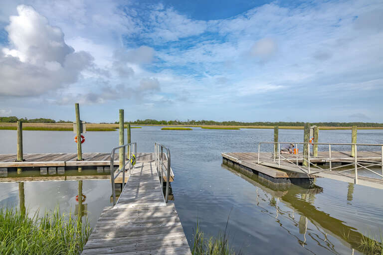 Serene Waterfront Vacation Rental Scene With Floating Docks And Expansive Sky