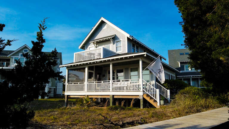 White Wooden House With Balconies, Blue Sky Background