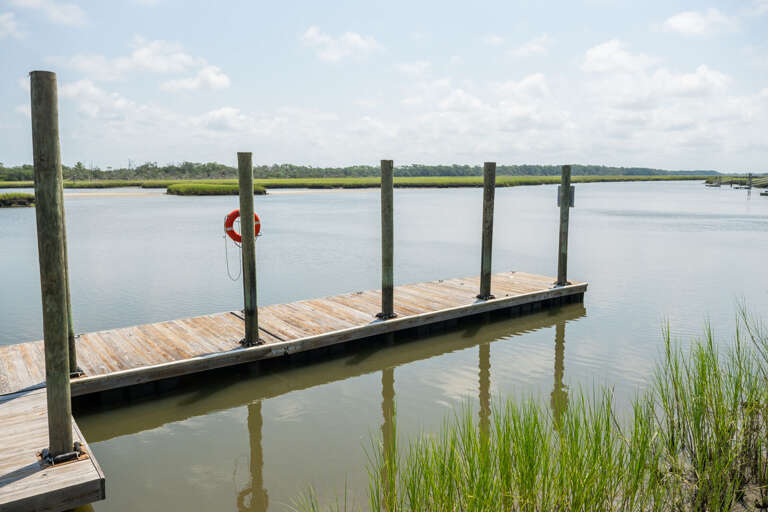 Wooden Walkway Waterside, With Grass Green And Sky Vast