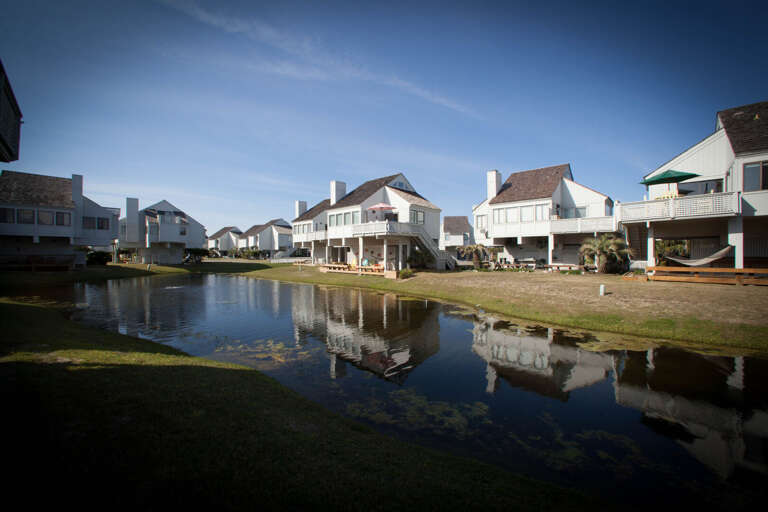 Waterfront Vacation Rentals Reflecting In Peaceful Pond