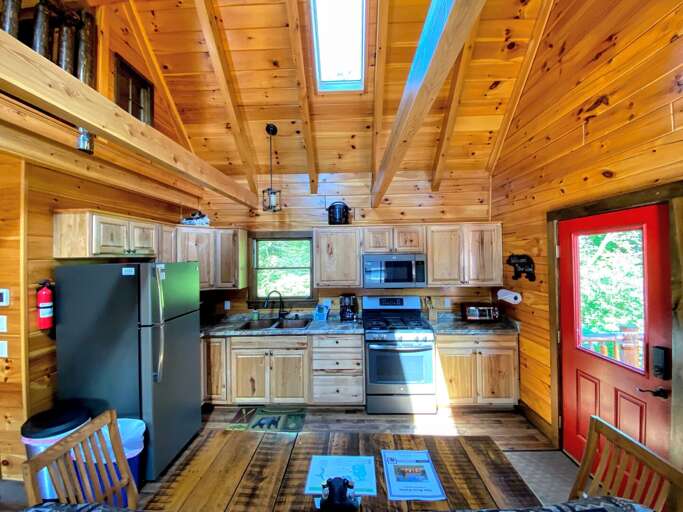 Kitchen and Dining. Table has two chairs and two benches