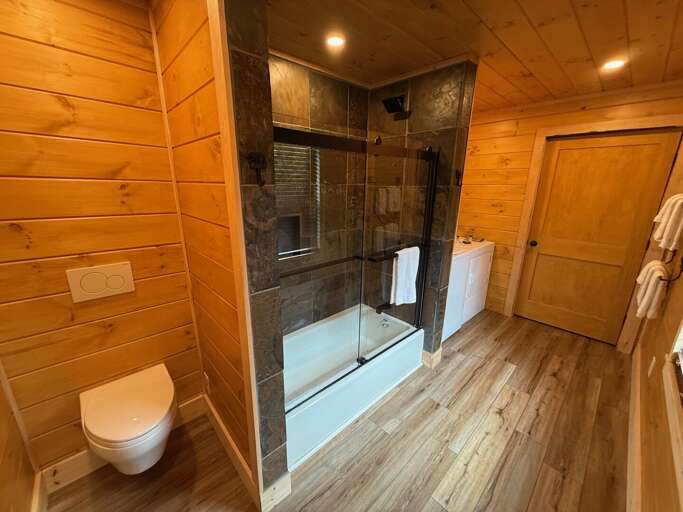 The new primary bathroom includes a beautiful tiled shower/tub combo, washer and dryer, and heated floors!