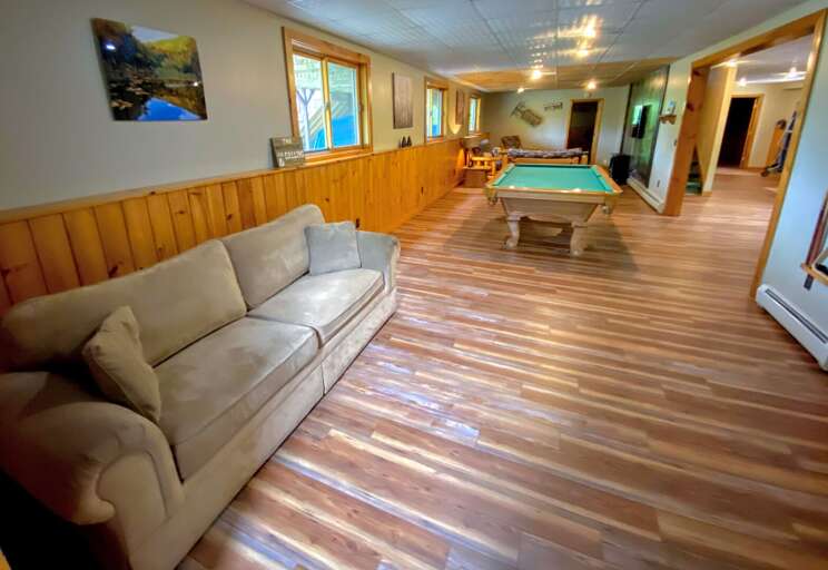 Side view of the downstairs entertainment area. The TV area is in the background, beyond the pool table, and the foosball table is off to the right, past the second kitchen (not visible in this photo)